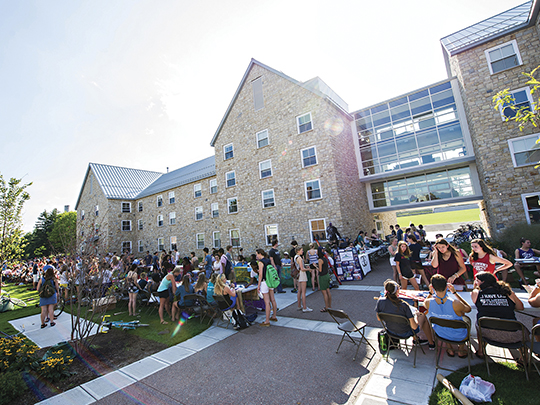 students seated outside curing event