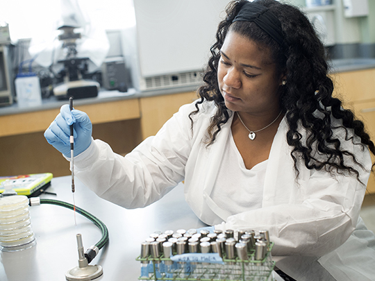 student using chemistry pipette
