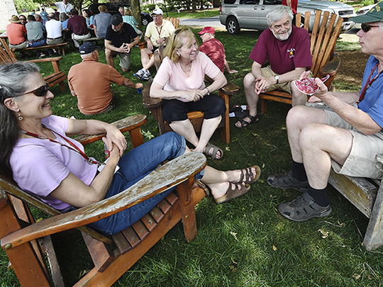 Alumni sitting in lawn chairs