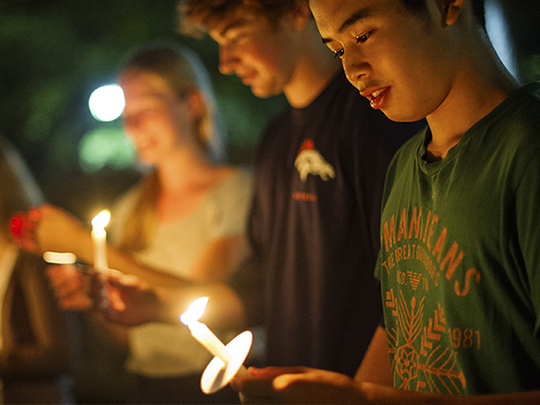 students holding candles